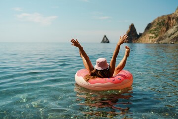 Summer vacation woman in hat floats on an inflatable donut mattress. Happy woman relaxing and enjoying family summer travel holidays travel on the sea. - obrazy, fototapety, plakaty