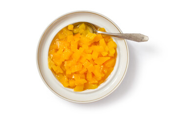 Pumpkin jam in a plate on a white background. White plate with jam and spoon.