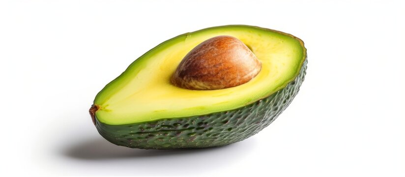 Half of an avocado photographed alone on a white backdrop - Stock image