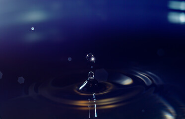 Naklejka na ściany i meble Clear aqua water droplet splashing in concentric circles, capturing refreshing purity.