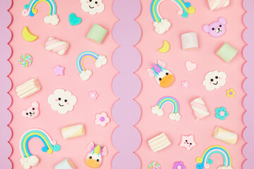 Trendy pastel pink kawaii background with cute air plasticine handmade cartoon animals, unicorns, stars, sweet marshmallows, rainbows pattern. Top view, flat lay. Candycore, fairycore.