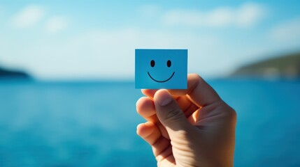 Smiley face icon on a blue cube in the hand