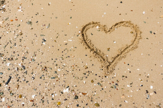drawn heart in the sandy beach on vacation