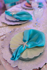 Teal napkins with glittery starfish napkin ring as table setting