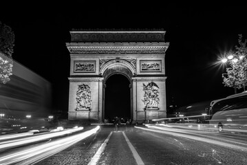 Fototapeta na wymiar Nightly traffic on the Champs-Elysees and Arc de Triomph