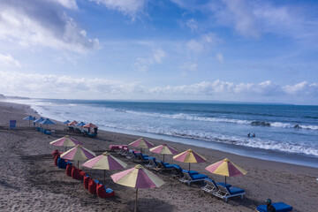 Rows of beach umbrellas in Canggu area in Bali
