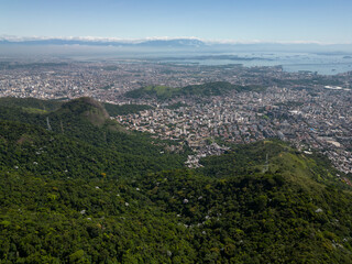 Beautiful aerial view to green rainforest mountains and city