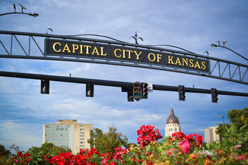 Capital City of Kansas Arch Signage Over Capitol Dome and Flowers
