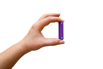 Hand holds AA battery on transparent background