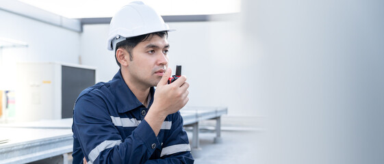 Asian maintenance engineer working on color background, contractor inspect compressor system and...