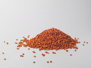 pearl gold masterbatch granules on a white background, this polymer is a product colorant for...