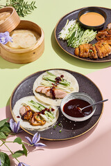 Elegant Peking duck served with pancakes, fresh cucumber, and hoisin sauce on a modern table setting.