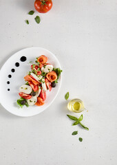 Artistic top view of Caprese salad with tomatoes, mozzarella, and salmon, ideal for light dining concepts and healthy lifestyle promotion