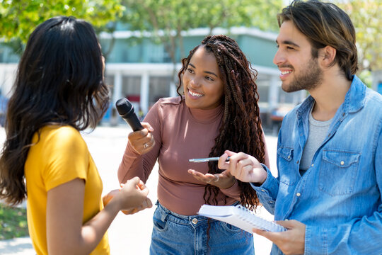 African american female journalist with latin reporter at interview