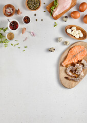 Nutritious food composition with protein-rich ingredients - fish, chicken, shrimp, cheese, and fresh greens, top view with copy space for healthy lifestyle guides