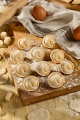 Pelmeni on a wooden board, a rustic scene showcasing Slavic culinary traditions