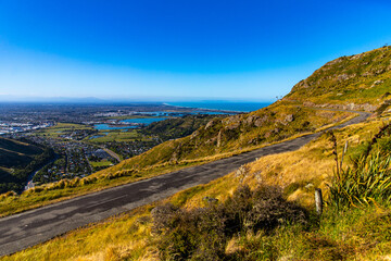 Fototapeta premium panorama of christchurch city as seen from the summit road, bridle path with scenic view of the city, canterbury, new zealand south island