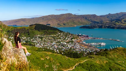 Foto op Plexiglas pretty hiker girl enjoying the panorama of lyttelton after finishing the hike on the briddle path from christchurch to lyttelton  beautiful view from gondola summit station, canterbury, new zealand  © Jakub