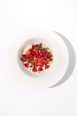 Top View of Beetroot Ravioli Bows in Cream Sauce, Beautifully Served for Gourmet Italian Dining Experiences