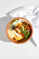 Scrambled omelet with shrimp, tomato salsa, and cheese mousse on a white fabric napkin, top view