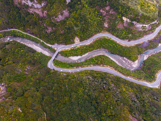aerial panorama of the west coast of new zealand south island; winding road next to turquois water, mighty cliffs and little islands, ten mile creek near greymouth and paparoa national park	