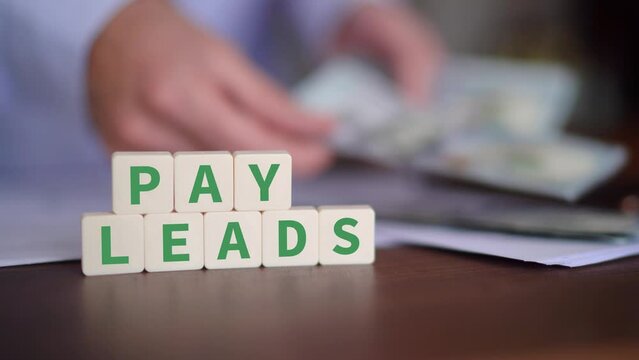 Concept of paying for leads as a strategy. Selective focus with money on the background.