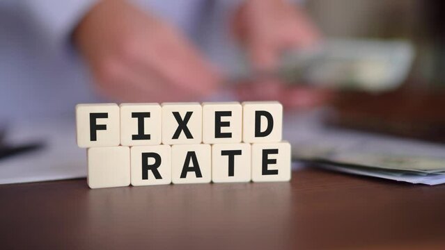 Concept of paying a fixed rate loan. Mortgage payment with Selective focus and a person counting money on the background.