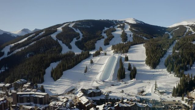 Aerial Drone Copper Mountain Colorado Ikon Epic Pass winter spring sunny first light sunrise morning sunset half pipe chairlift ski runs center village cinematic slowly down jib motion