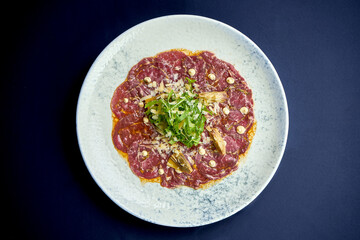 Italian carpaccio with artichokes, arugula in a plate. A delicious snack