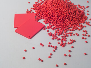 masterbatch granules and color chips (example of the resulting color) pink peach on a white background, this polymer is a colorant for products in the plastics industry