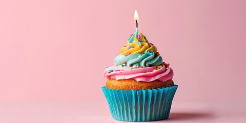 Happy birthday concept with cupcake and burning candle on colorful background and blank copy space