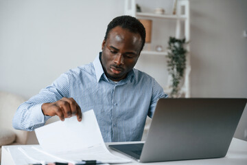 Businessman is working in the office by laptop