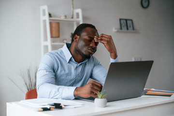 Feeling bad, stressful. Businessman is working in the office by laptop