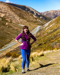 Naklejka na ściany i meble adventurous hiker girl on the way to the top of trig m, scenic peak in new zealand alps, near arthur's pass village and lake lyndon; 