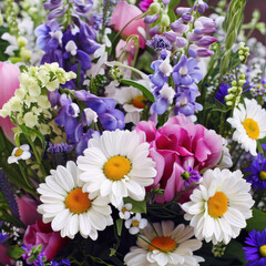 A beautiful summer bright bouquet of different flowers including sunflowers, roses, lavender and daisies