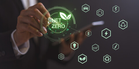 Net zero and climate neutral concept. Emissions Goals Weather neutral long-term strategy. Businessman pointing on net zero icon with decarbonization icon on virtual screen.
