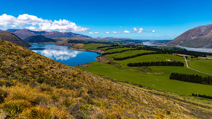 idyllic panorama of lake coleridge, rakaia gorge and alp moutains seen from the top of peak hill in canterbury, new zealand south island