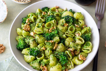 Pasta with broccoli, pesto sauce and nuts. Italian cuisine. Healthy eating.