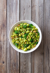 Pasta with broccoli, pesto sauce and nuts. Italian cuisine. Healthy eating.