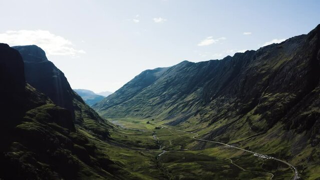Wide drone shot of Scotland's famous Glencoe Valley at midday.