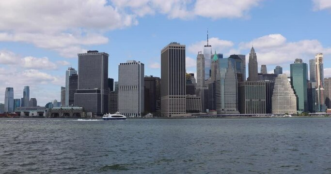 Experience the dynamic Downtown NYC view from Brooklyn, capturing boats on the water. A cinematic blend of urban skyline and waterfront activity.