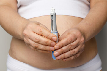 Woman showing opened Semaglutide Injection pen or insulin cartridge pen. Weight loss and diabetes...
