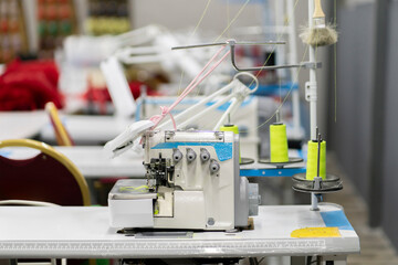 the overlock. automatic sewing machine on the textile production factory