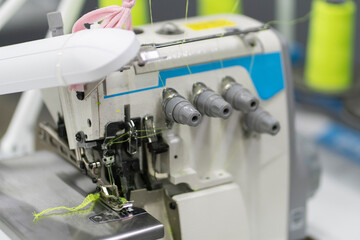 the overlock. automatic sewing machine on the textile production factory