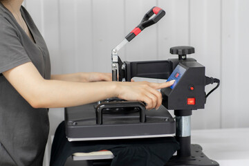 making print on t-shirt using press in the clothing manufacture
