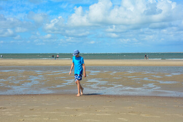 Fototapeta na wymiar A boy on the beach at low tide