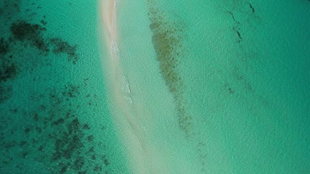 Clear turquoise waters and sandy path at los roques archipelago, venezuela, serene nature scene, aerial view