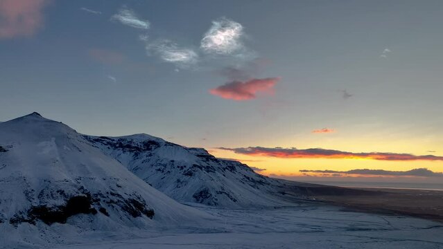 Polar Stratospheric Clouds Over Snowy Mountains In South Iceland. drone shot