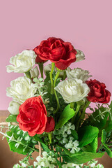 bouquet of red, white and pink roses on pink background. Closeup
