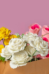 Bouquet of white roses and yellow roses in box on pink background. valentines day concept